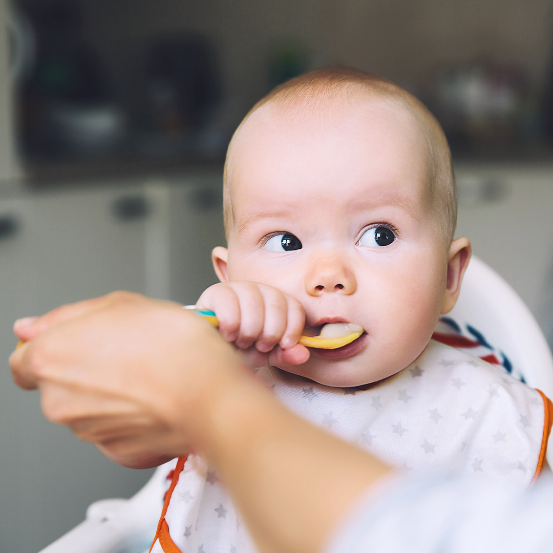 Banner baby eating porridge