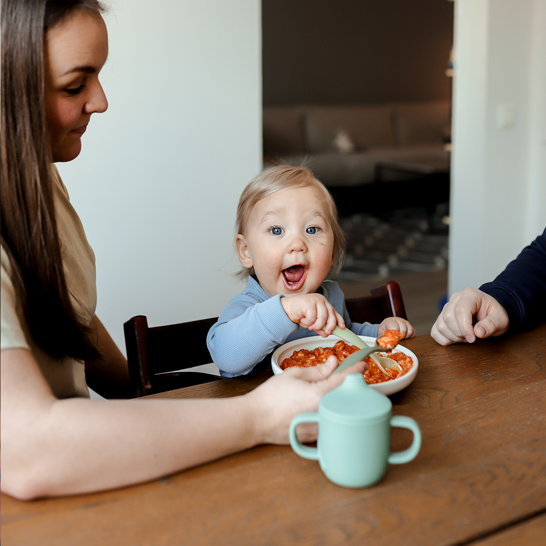 happy baby eating Semper baby food