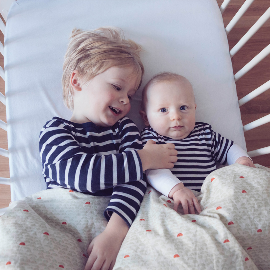 Siblings in crib