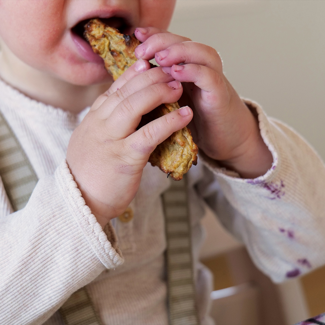 Baby eating porridge stick